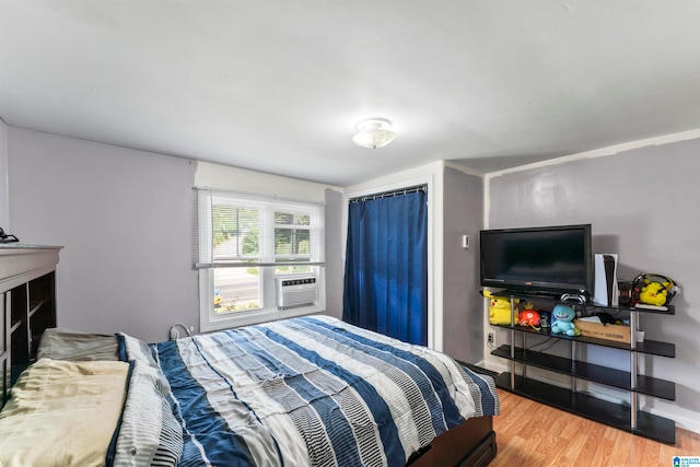 bedroom with light hardwood / wood-style flooring and cooling unit