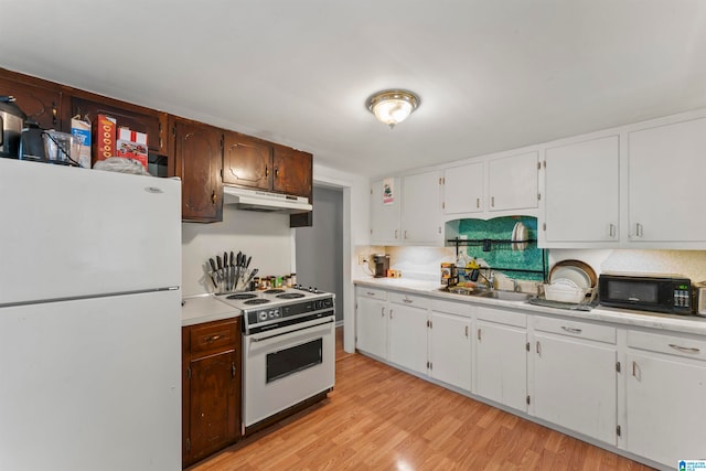 kitchen with light wood-type flooring, sink, white appliances, and white cabinets