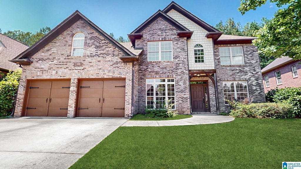 view of front facade with a front yard and a garage