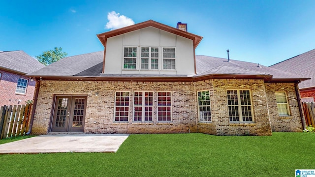 rear view of house featuring a patio area, a yard, and french doors