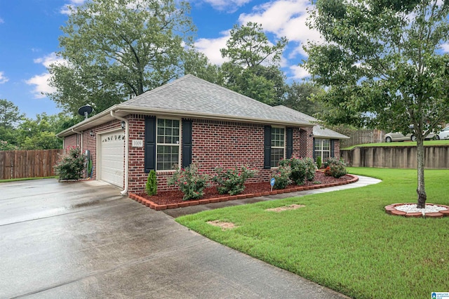 view of front of home with a front yard and a garage