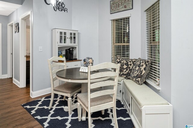 dining area with hardwood / wood-style floors and an inviting chandelier