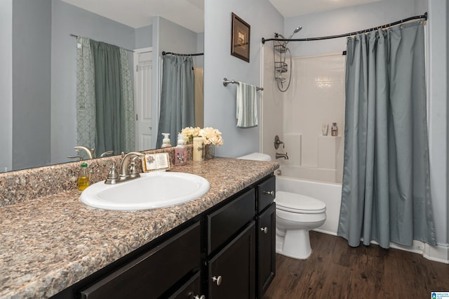 full bathroom with vanity, toilet, shower / tub combo, and hardwood / wood-style floors