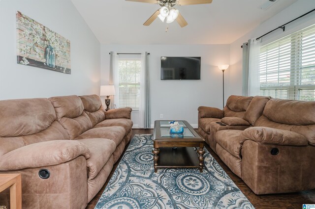 living room featuring plenty of natural light, ceiling fan, and dark hardwood / wood-style floors