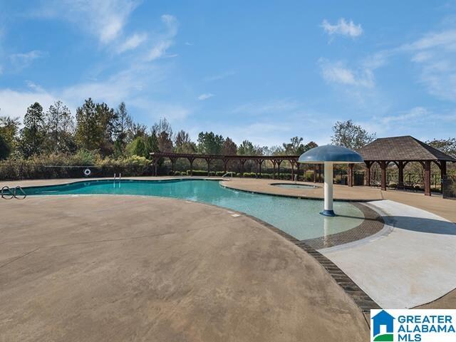 view of swimming pool featuring a patio area and a gazebo