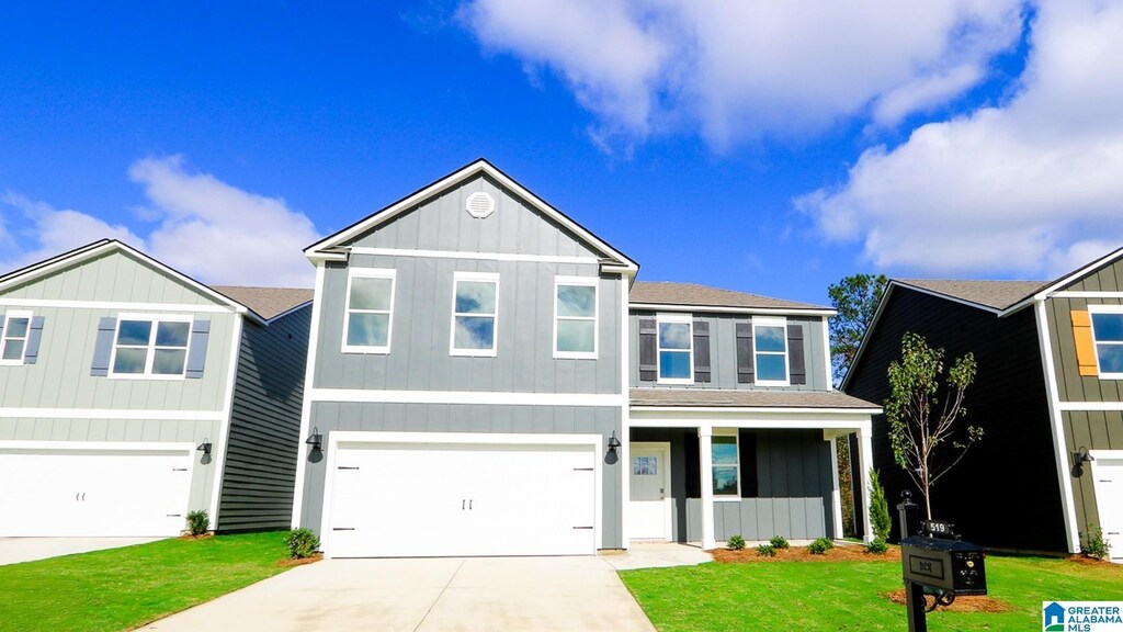view of front of property featuring a front lawn and a garage