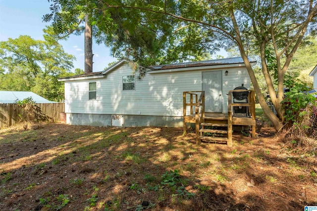 back of house with a wooden deck