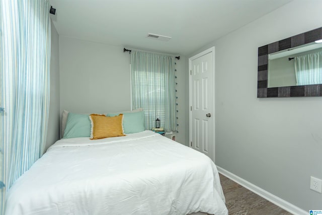 bedroom featuring dark hardwood / wood-style flooring