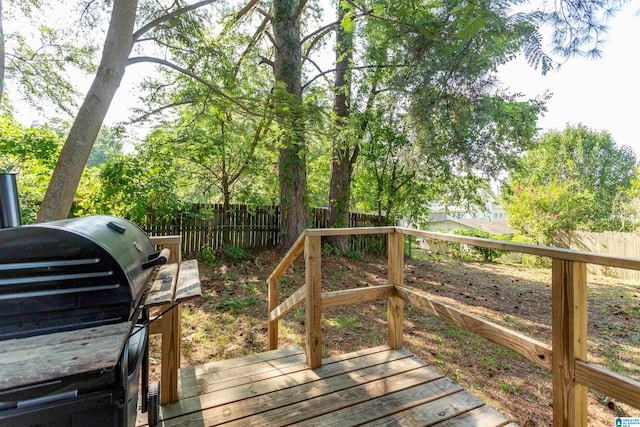 wooden deck featuring a grill