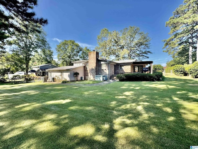 exterior space featuring a chimney and a front lawn