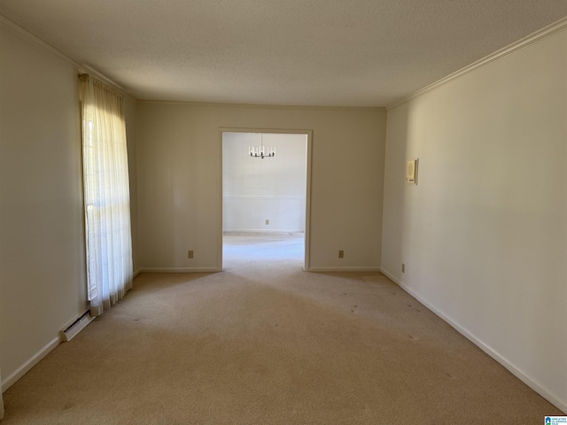 spare room with a textured ceiling, baseboards, light colored carpet, and crown molding