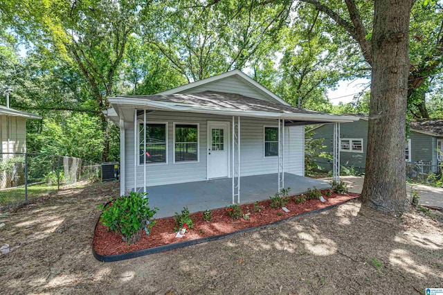 view of front of property with central air condition unit, covered porch, and fence