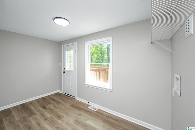 interior space featuring visible vents, baseboards, and wood finished floors