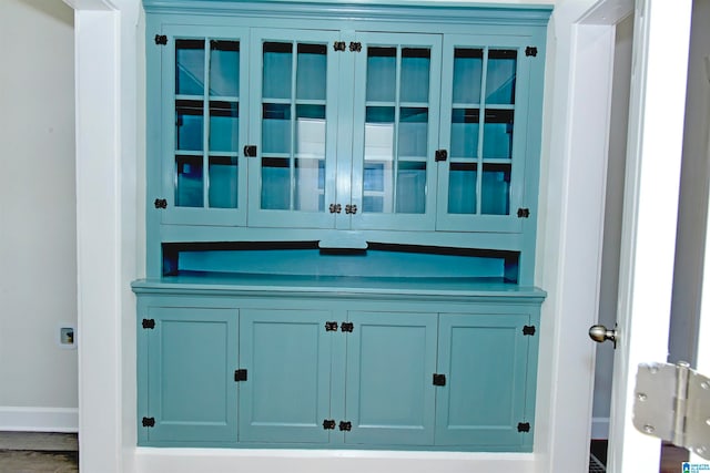 bar with blue cabinetry