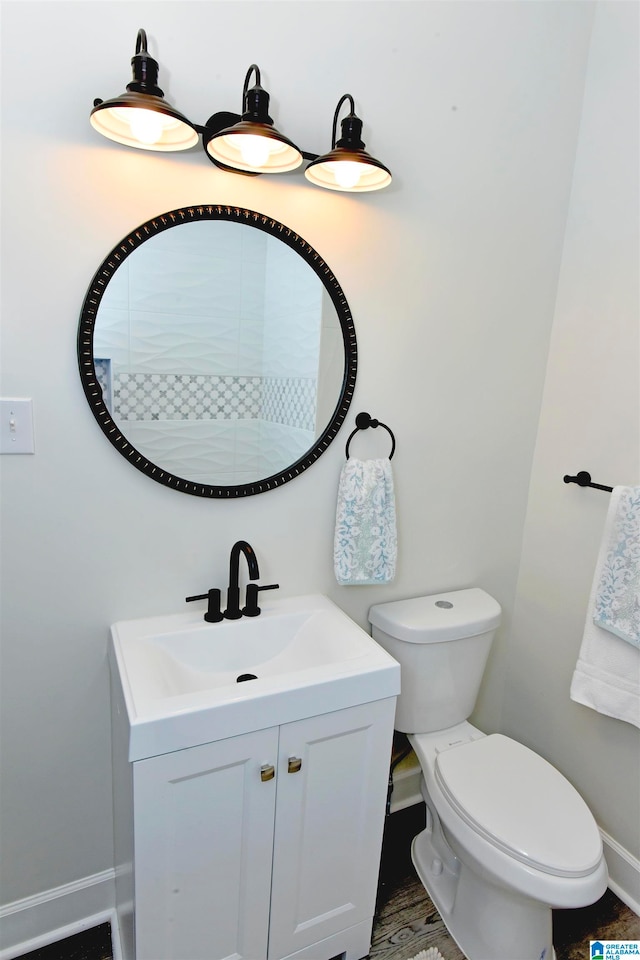 bathroom featuring vanity and toilet