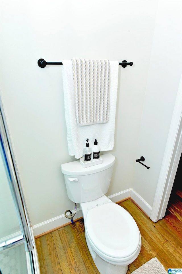 bathroom featuring toilet and hardwood / wood-style floors