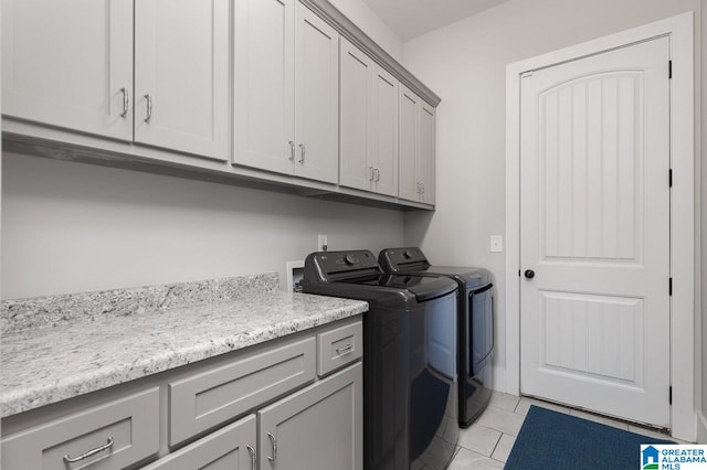 laundry room with cabinets, independent washer and dryer, and light tile patterned floors