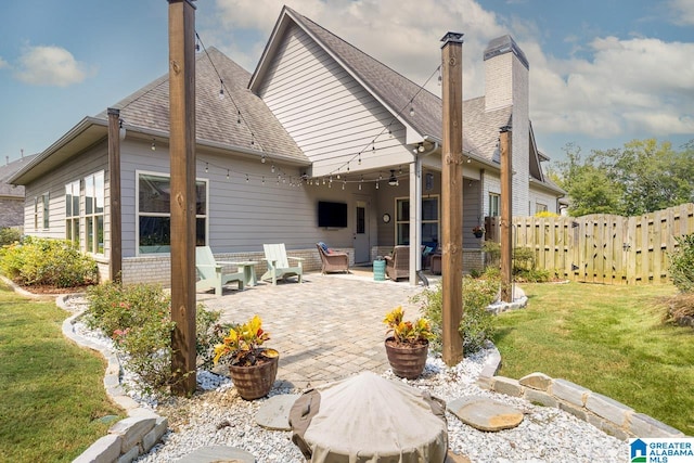 rear view of house with a yard and a patio area