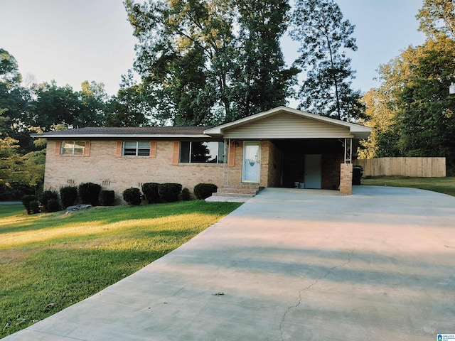 view of front of property with driveway, a front lawn, and brick siding