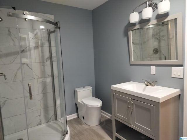 full bathroom with toilet, a stall shower, wood finished floors, and vanity