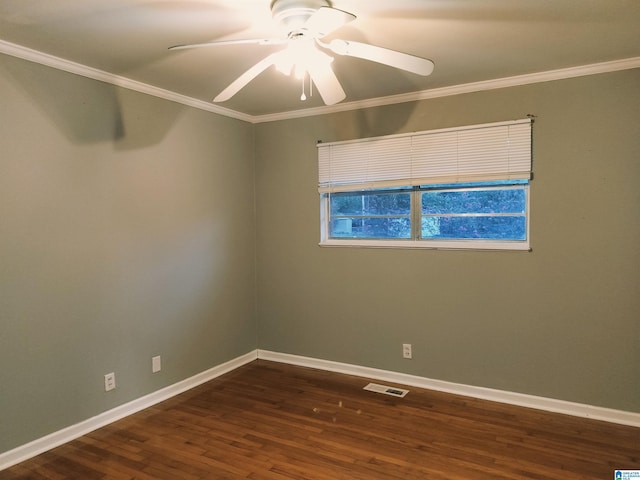 spare room featuring ornamental molding, dark wood-type flooring, visible vents, and baseboards