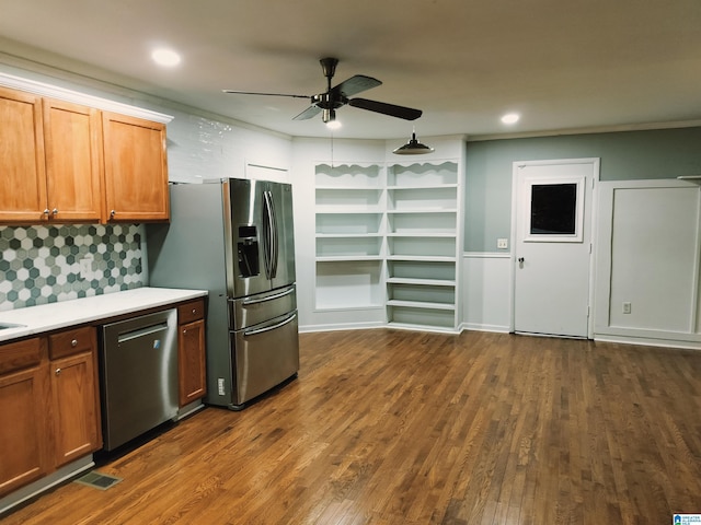 kitchen with dark wood-type flooring, visible vents, light countertops, appliances with stainless steel finishes, and brown cabinetry