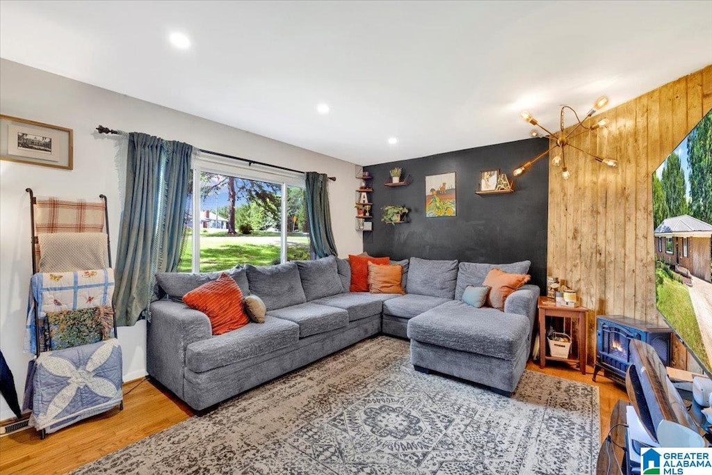 living room featuring wood walls and wood-type flooring