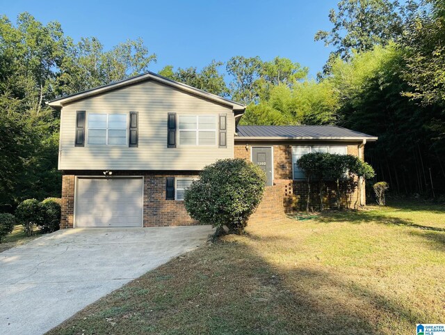 tri-level home featuring a garage and a front yard