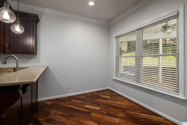 dining room with ornamental molding and dark hardwood / wood-style floors