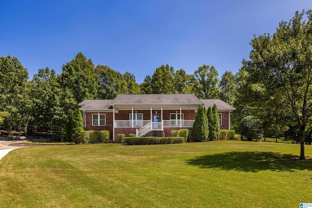 single story home with a front lawn and covered porch