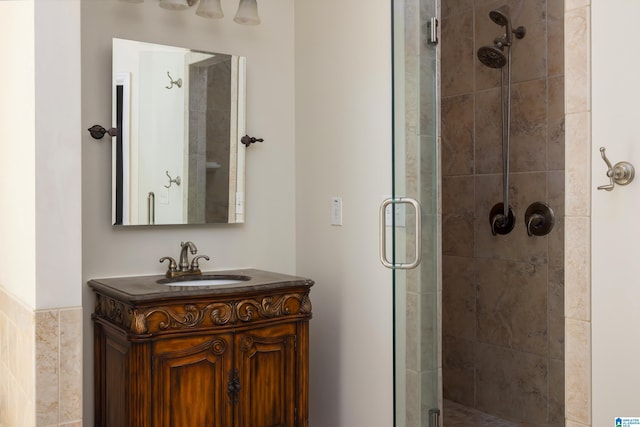 bathroom featuring vanity and an enclosed shower