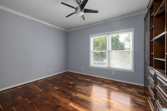 spare room featuring crown molding, dark wood-type flooring, and ceiling fan