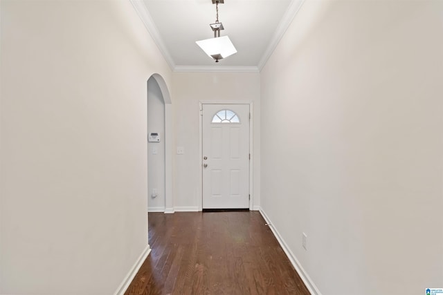 doorway with crown molding and dark hardwood / wood-style floors