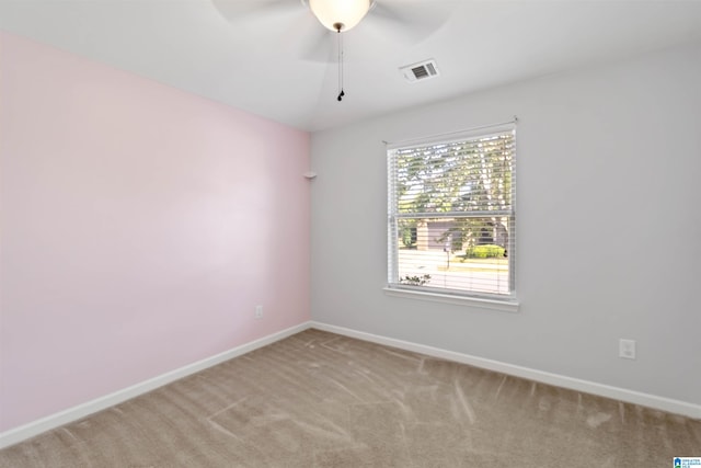 carpeted spare room featuring ceiling fan