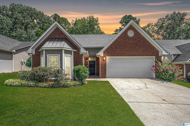 view of front of house featuring a garage and a yard