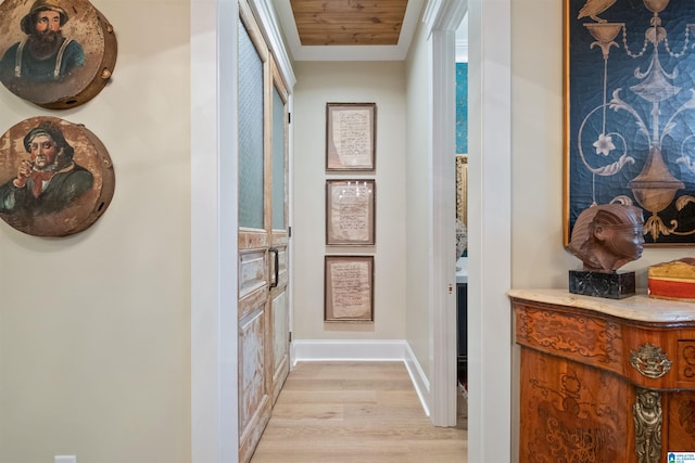 hallway featuring light wood-style floors and baseboards