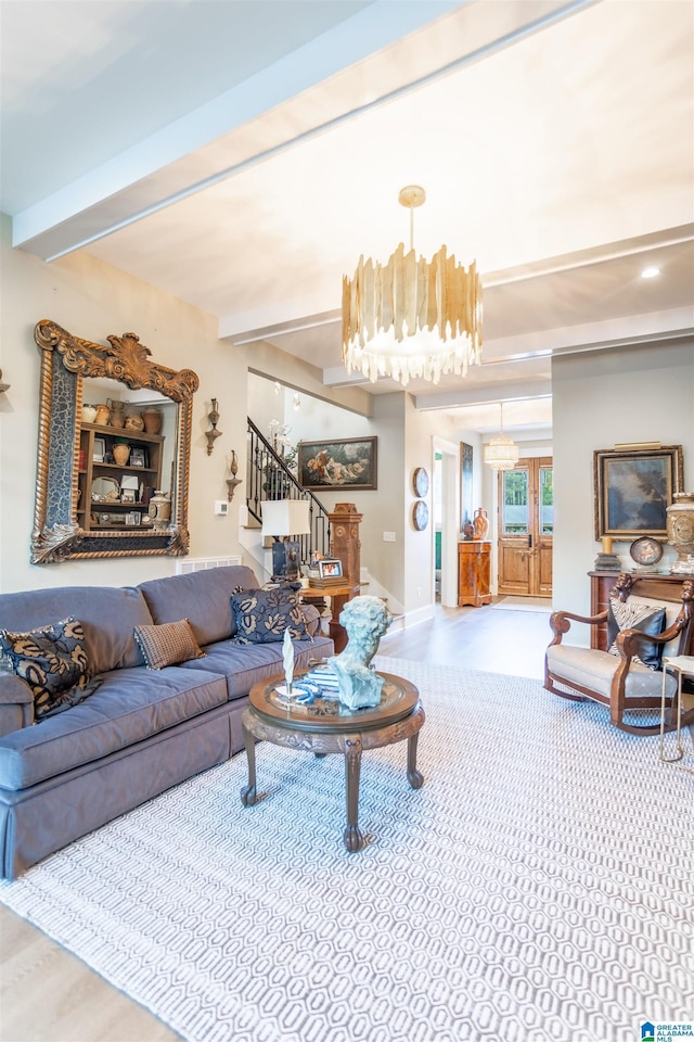 living area with stairs, beamed ceiling, and a notable chandelier