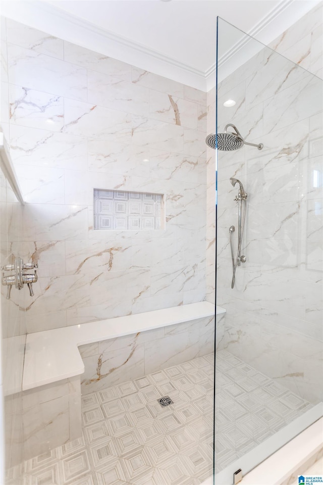 full bath featuring a marble finish shower and crown molding