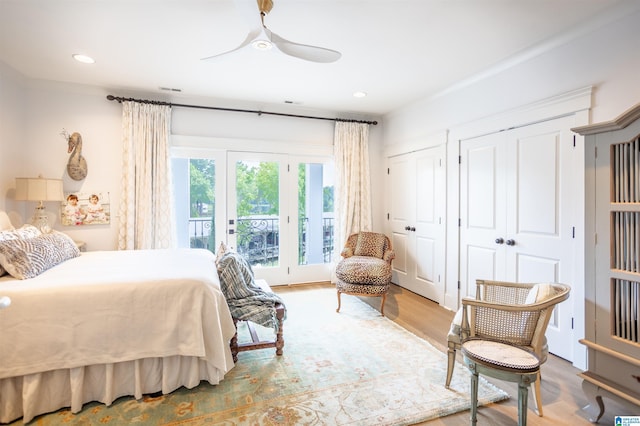 bedroom featuring recessed lighting, wood finished floors, a ceiling fan, access to exterior, and two closets