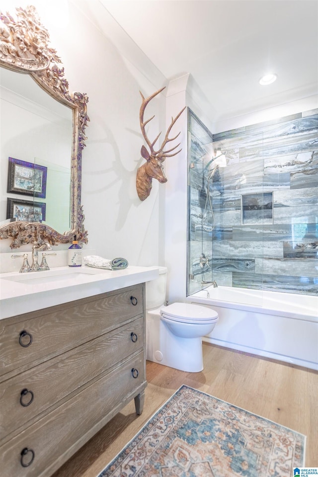 bathroom featuring wood finished floors, bathing tub / shower combination, toilet, and vanity