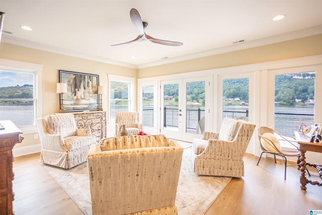 sunroom with visible vents, a ceiling fan, and french doors