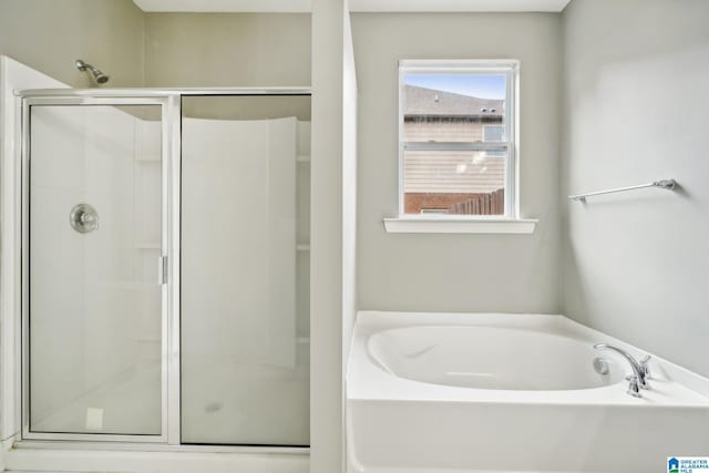 full bath featuring a shower stall and a bath