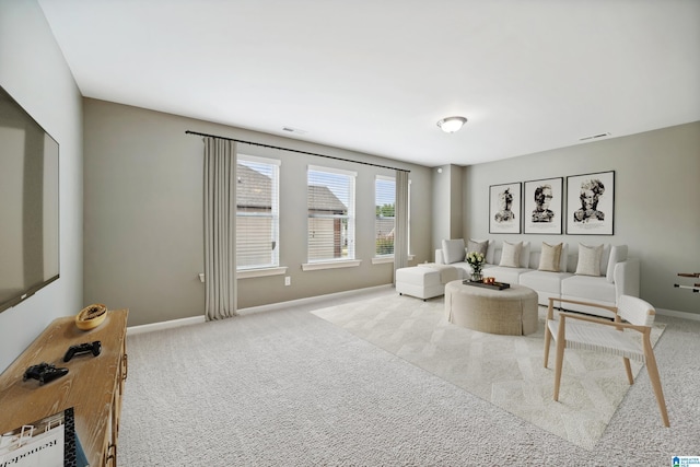 living room featuring visible vents, baseboards, and carpet floors