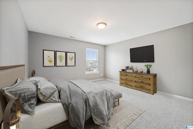 carpeted bedroom featuring visible vents and baseboards