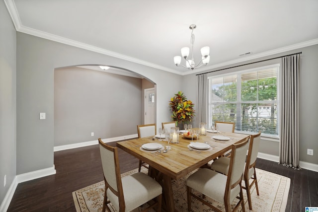 dining space featuring baseboards, arched walkways, dark wood-type flooring, crown molding, and a notable chandelier