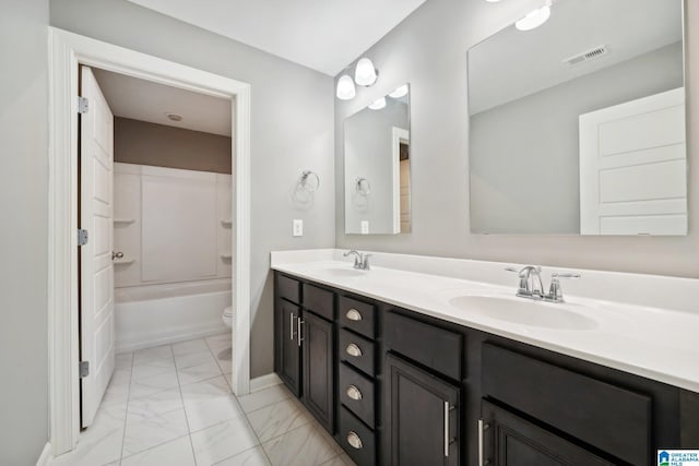 bathroom with double vanity, visible vents, marble finish floor, and a sink