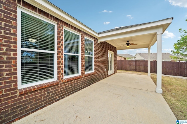 view of patio featuring fence and ceiling fan