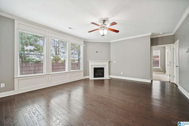 unfurnished living room with visible vents, a fireplace, dark wood-style flooring, and crown molding