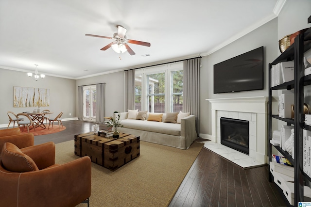 living room featuring hardwood / wood-style floors, a tiled fireplace, and ornamental molding