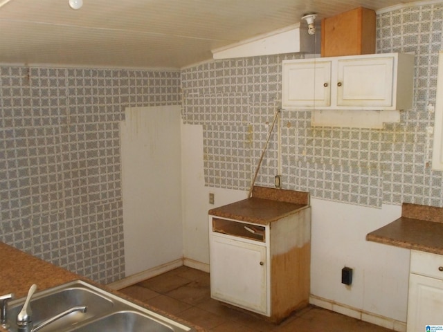 kitchen featuring a sink, white cabinetry, and tile patterned floors